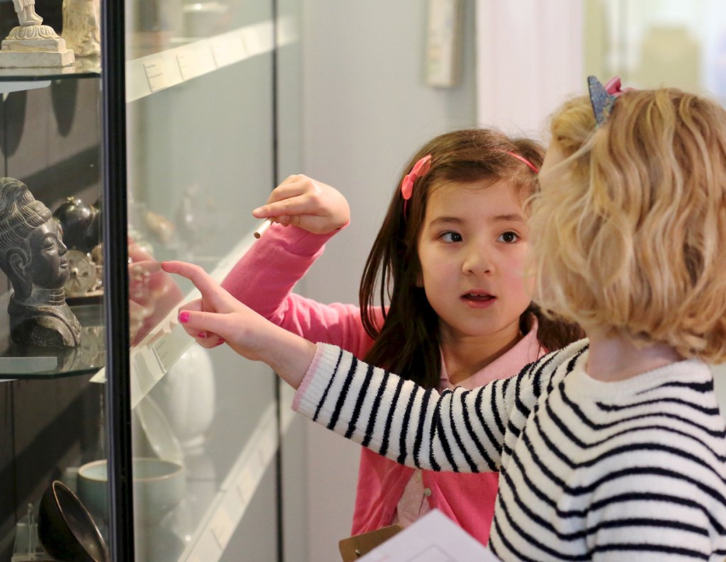 Children are looking at the objects in the display